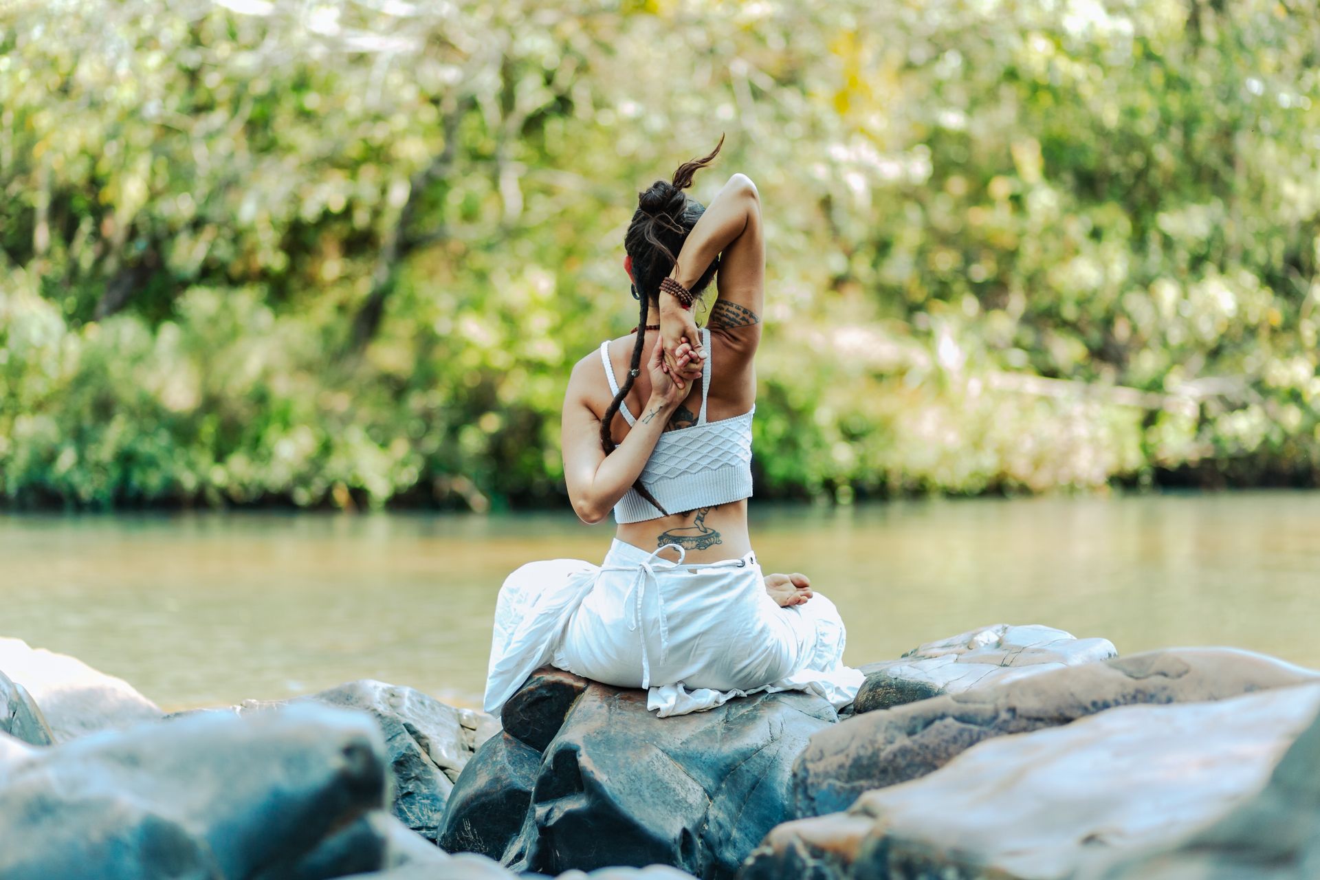 Girl in White Shirt and Black Pants Lying on Blue Exercise Ball